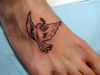 tribal dove tattoo on feet